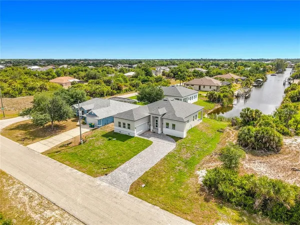 an aerial view of residential houses with outdoor space and swimming pool