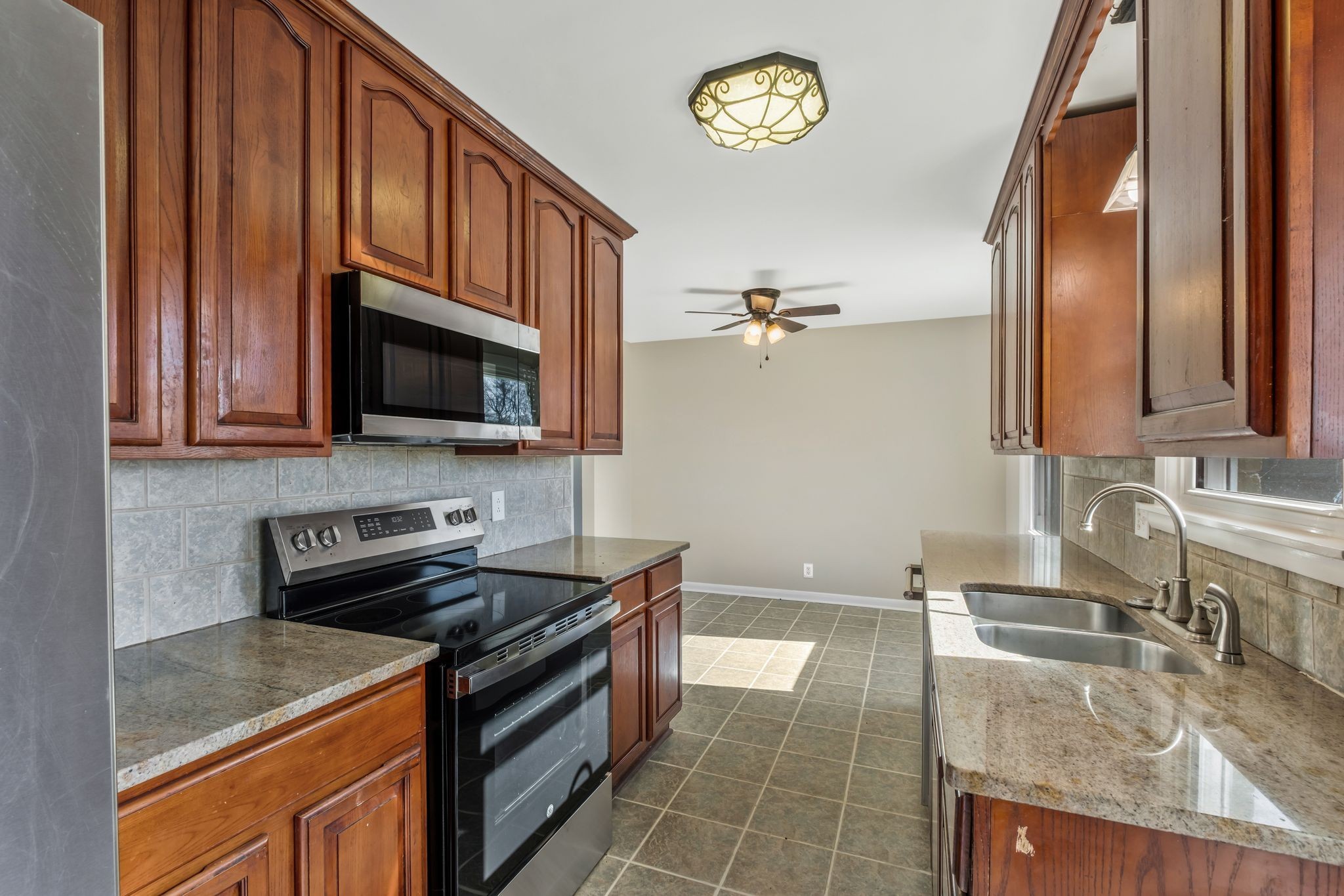 310 Santa Rosa Drive Old Hickory, TN 37138 - Photo 11 of 29 a kitchen with granite countertop a stove a sink and a microwave
