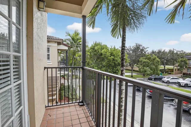 a balcony with view of palm trees