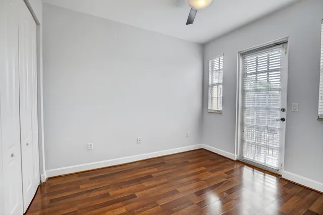 wooden floor in an empty room with a window