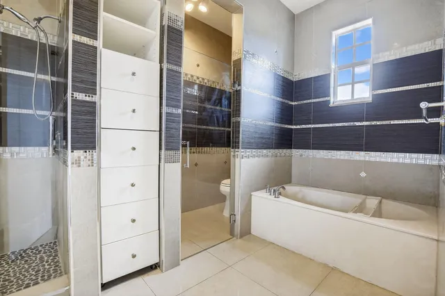 a bathroom with a bathtub and shower