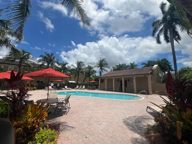 an outdoor space with patio and white umbrellas
