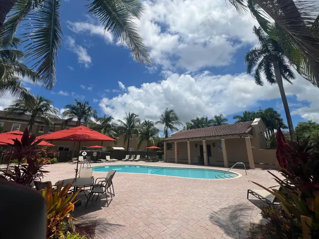 a view of a house with a yard and sitting area