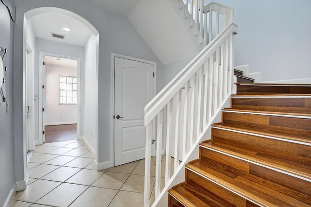a view of a hallway with wooden floor and entryway