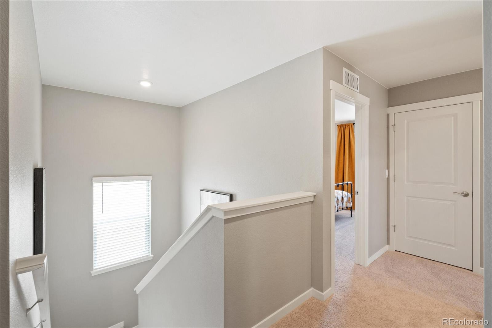 2233 Base Street Fort Lupton, CO 80621 - Photo 19 of 31 a view of hallway with window and wooden floor