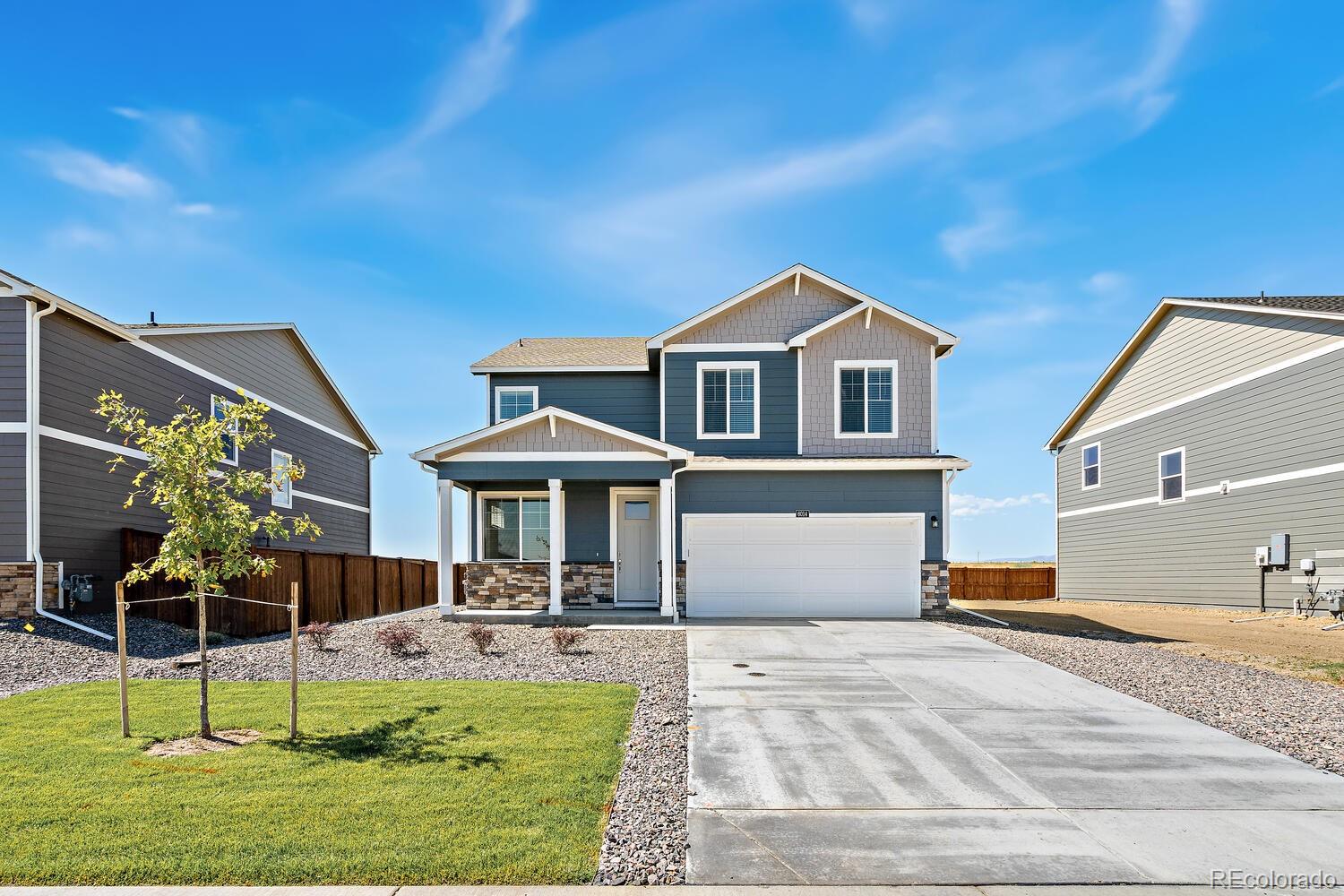 2233 Base Street Fort Lupton, CO 80621 - Photo 4 of 31 a front view of a house with a yard