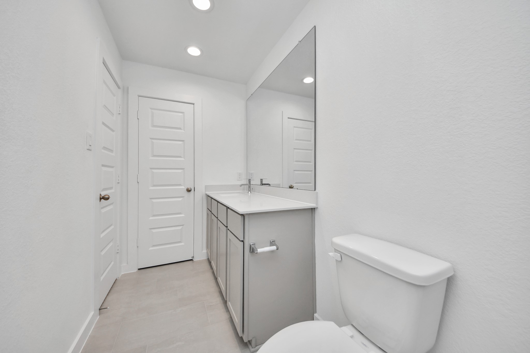 2926 Bury Park Dr Spring Spring, TX 77373 - Photo 29 of 40 Secondary bath features tile flooring, bath/shower combo with tile surround, light stained wood cabinets, beautiful light countertop.