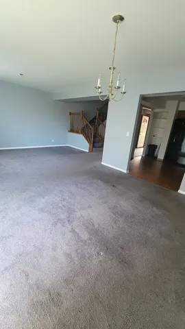 a view of a livingroom with furniture and chandelier