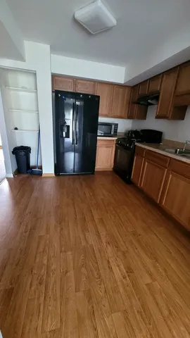 a view of a kitchen with a sink and a refrigerator