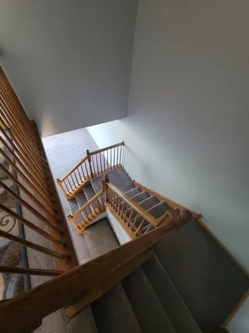 a view of staircase with white walls