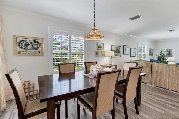 a view of a dining room with furniture window and wooden floor