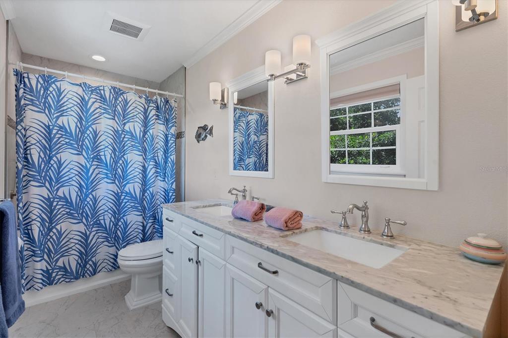 4010 40th Street West Boca Grande, FL 33921 - Photo 23 of 48 a bathroom with a granite countertop sink and mirror with toilet