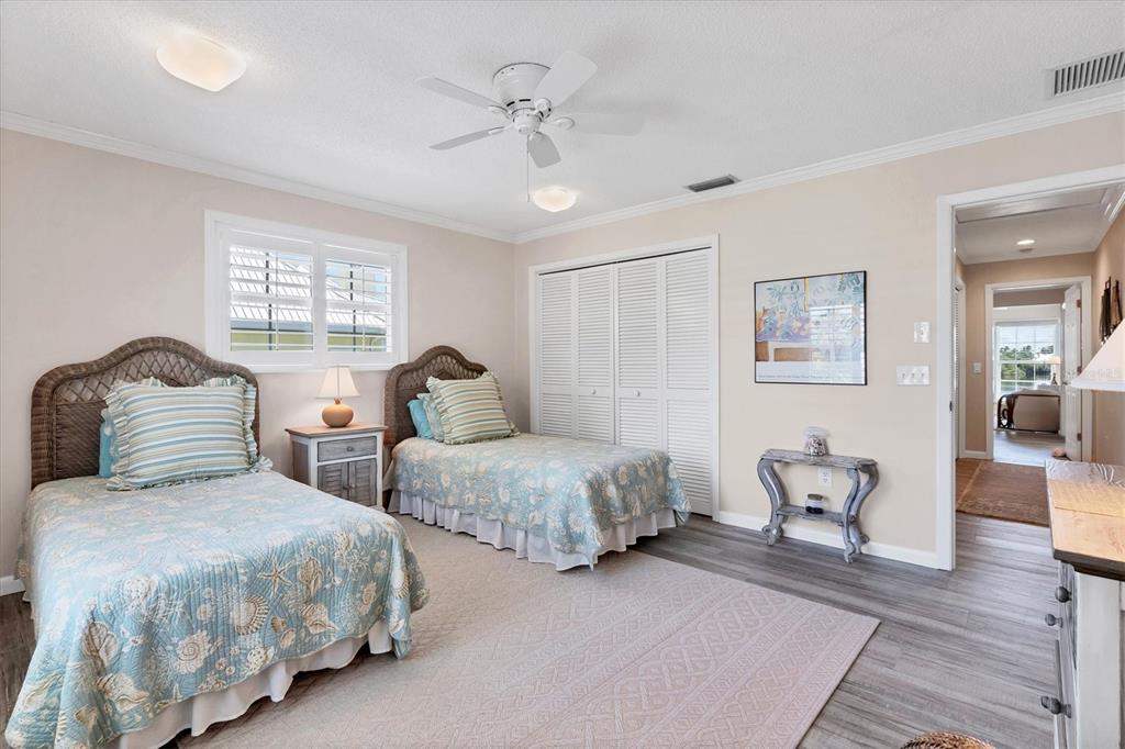 4010 40th Street West Boca Grande, FL 33921 - Photo 25 of 48 a bedroom with two beds and wooden floor