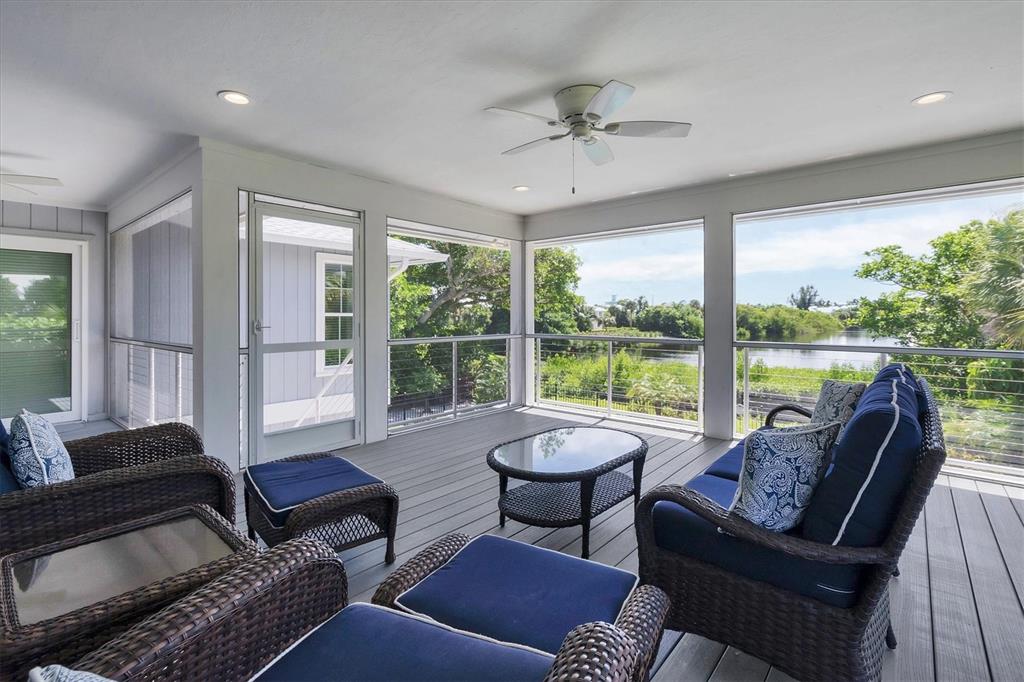 4010 40th Street West Boca Grande, FL 33921 - Photo 28 of 48 a living room with furniture and a floor to ceiling window