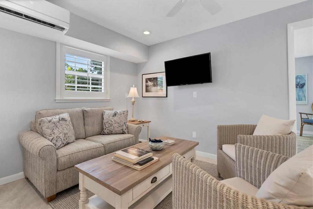 4010 40th Street West Boca Grande, FL 33921 - Photo 31 of 48 a living room with furniture a flat screen tv and a window