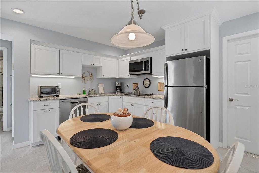 4010 40th Street West Boca Grande, FL 33921 - Photo 32 of 48 a kitchen with stainless steel appliances granite countertop a sink a refrigerator and a stove