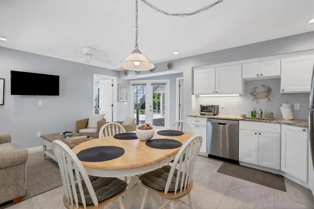 a view of a dining room with furniture and a chandelier