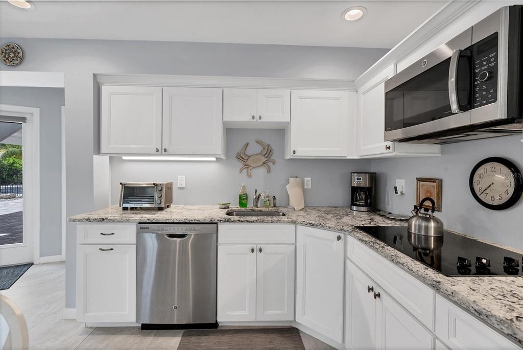 4010 40th Street West Boca Grande, FL 33921 - Photo 34 of 48 a kitchen with stainless steel appliances granite countertop a sink a stove a microwave and cabinets