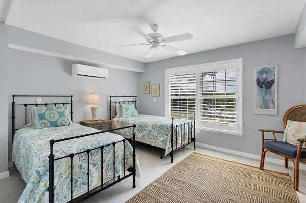 a bedroom with two beds and a window