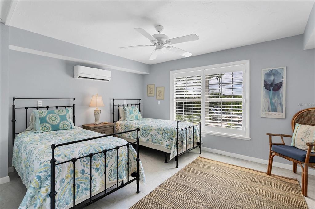 4010 40th Street West Boca Grande, FL 33921 - Photo 36 of 48 a bedroom with two beds and a window