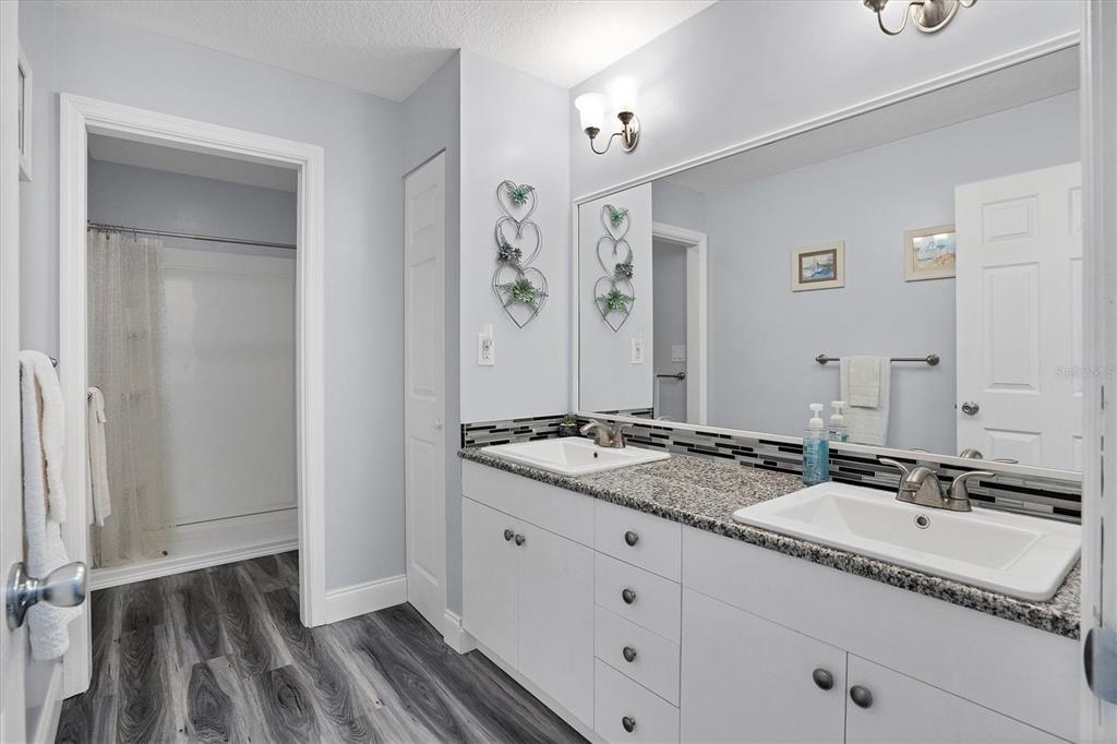 4010 40th Street West Boca Grande, FL 33921 - Photo 38 of 48 a bathroom with a granite countertop sink and a mirror