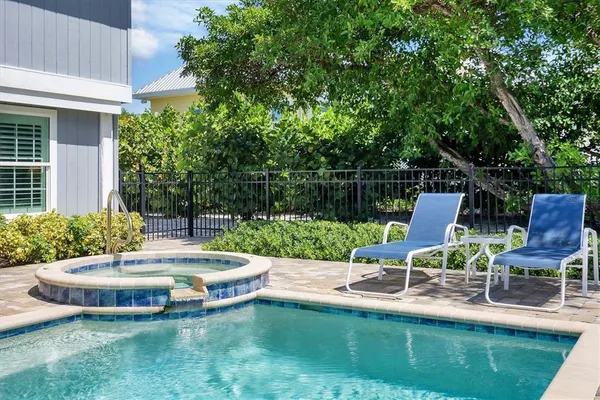 a view of a patio with couches chairs and a yard