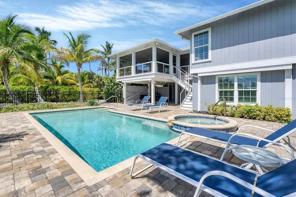 a view of a patio with swimming pool table and chairs