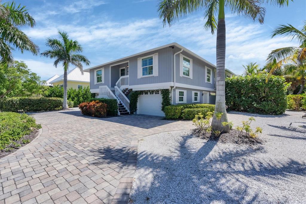 4010 40th Street West Boca Grande, FL 33921 - Photo 7 of 48 a front view of a house with a yard and a garage