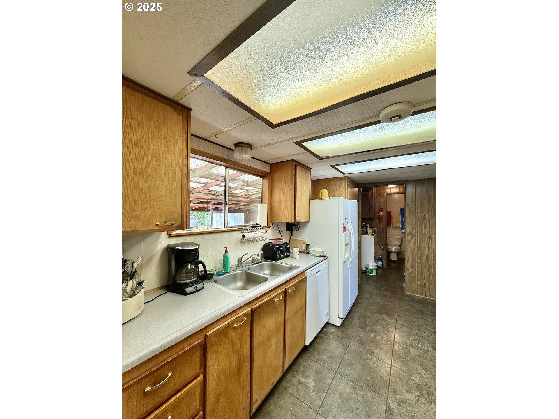 505 North 16th Avenue Elgin, OR 97827 - Photo 13 of 48 a kitchen with a sink and a refrigerator