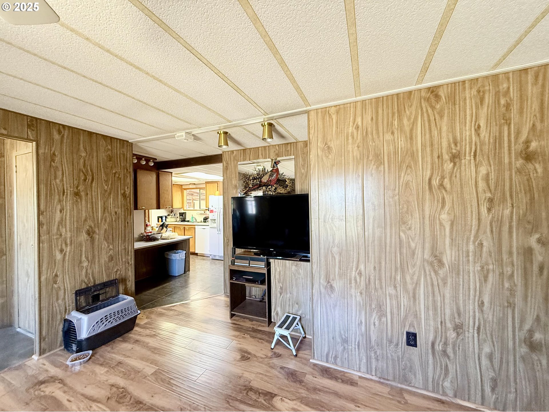 505 North 16th Avenue Elgin, OR 97827 - Photo 17 of 48 a view of a livingroom with furniture a flat screen tv and wooden floor