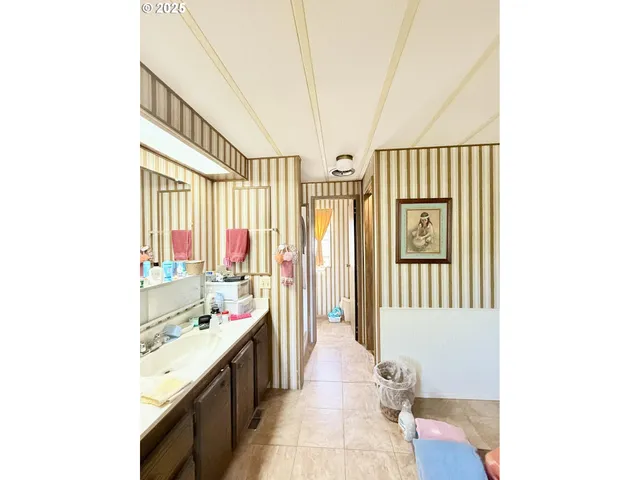 a spacious bathroom with a sink a mirror and a bathtub