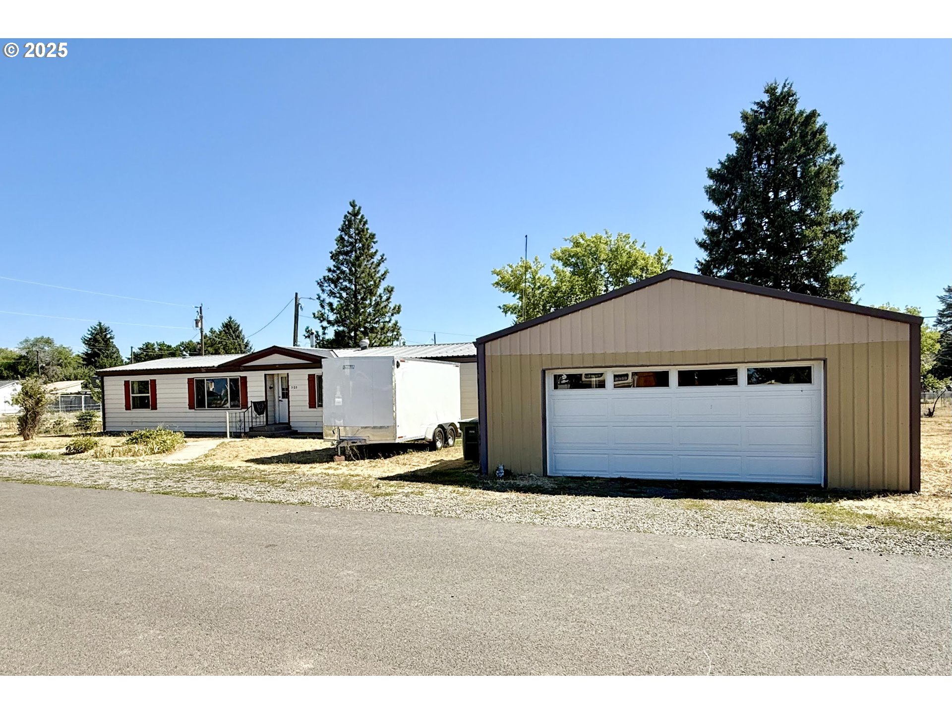505 North 16th Avenue Elgin, OR 97827 - Photo 3 of 48 a house with trees in front of it
