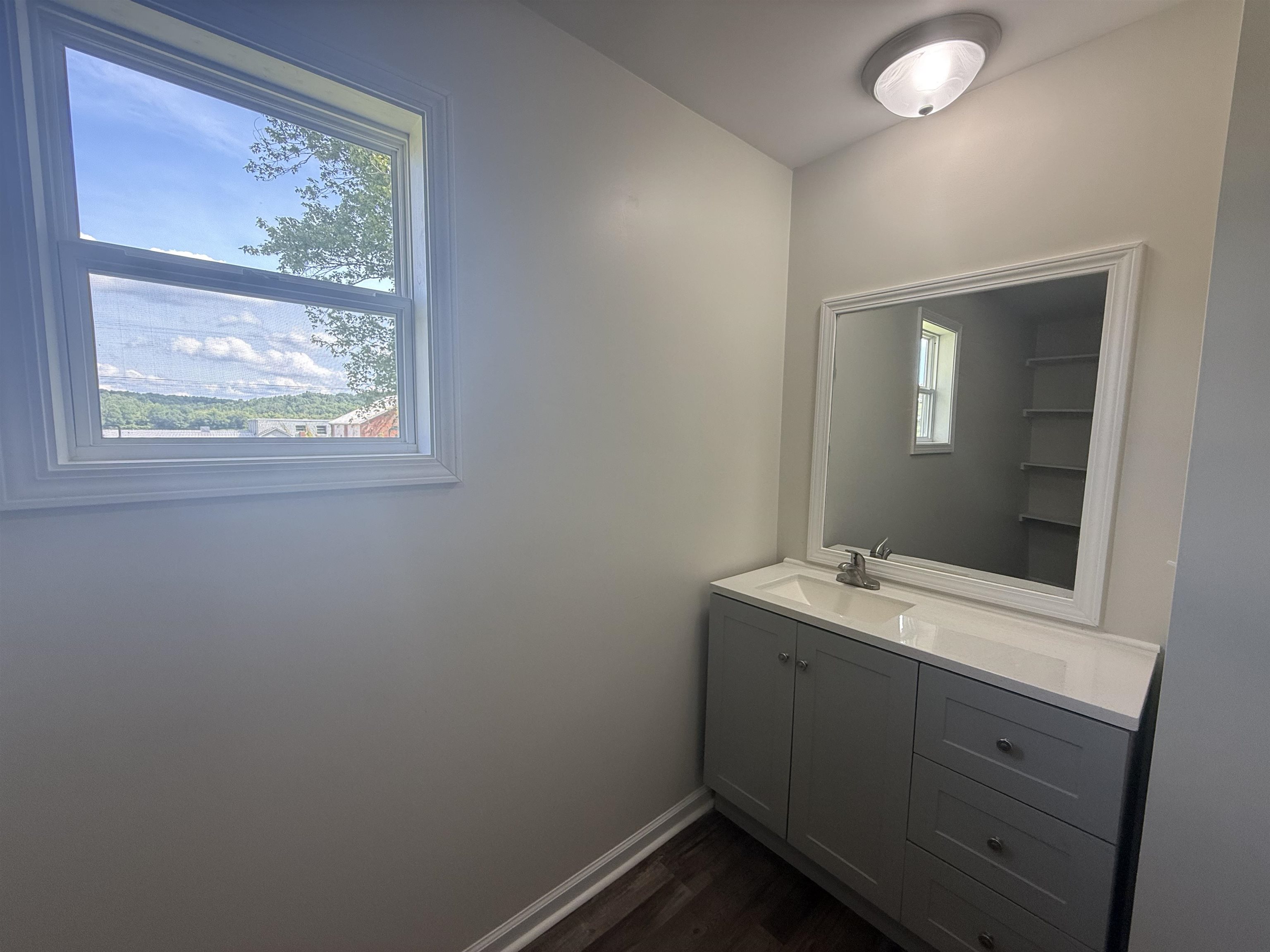 170 Leapwood Road Enville, TN 38332 - Photo 17 of 33 Contemporary vanity with gray cabinetry, white countertop, and integrated sink