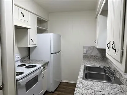 a kitchen with a stove and a refrigerator