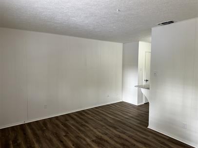 2002 Washington Street, Unit 1 Commerce, TX 75428 - Photo 6 of 6 a view of empty room with wooden floor