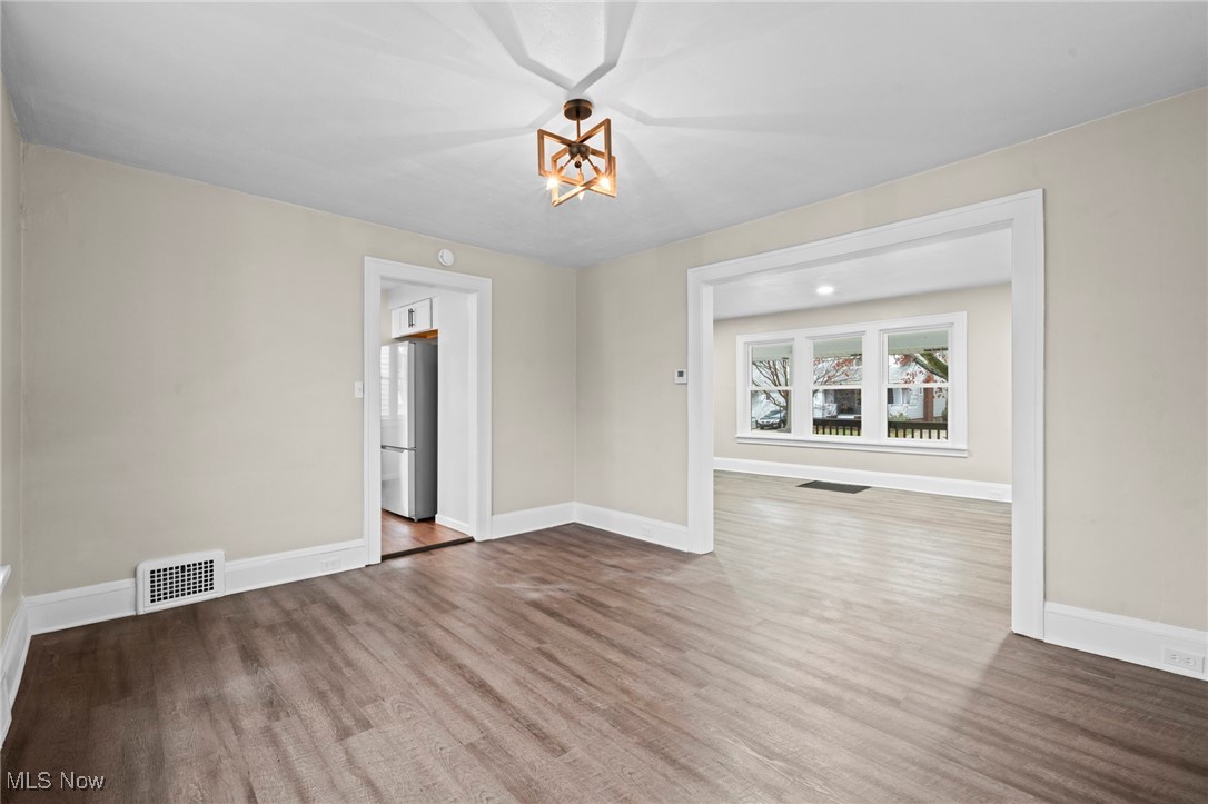 1056 Quilliams Road Cleveland, OH 44121 - Photo 9 of 37 Unfurnished room featuring wood finished floors and baseboards