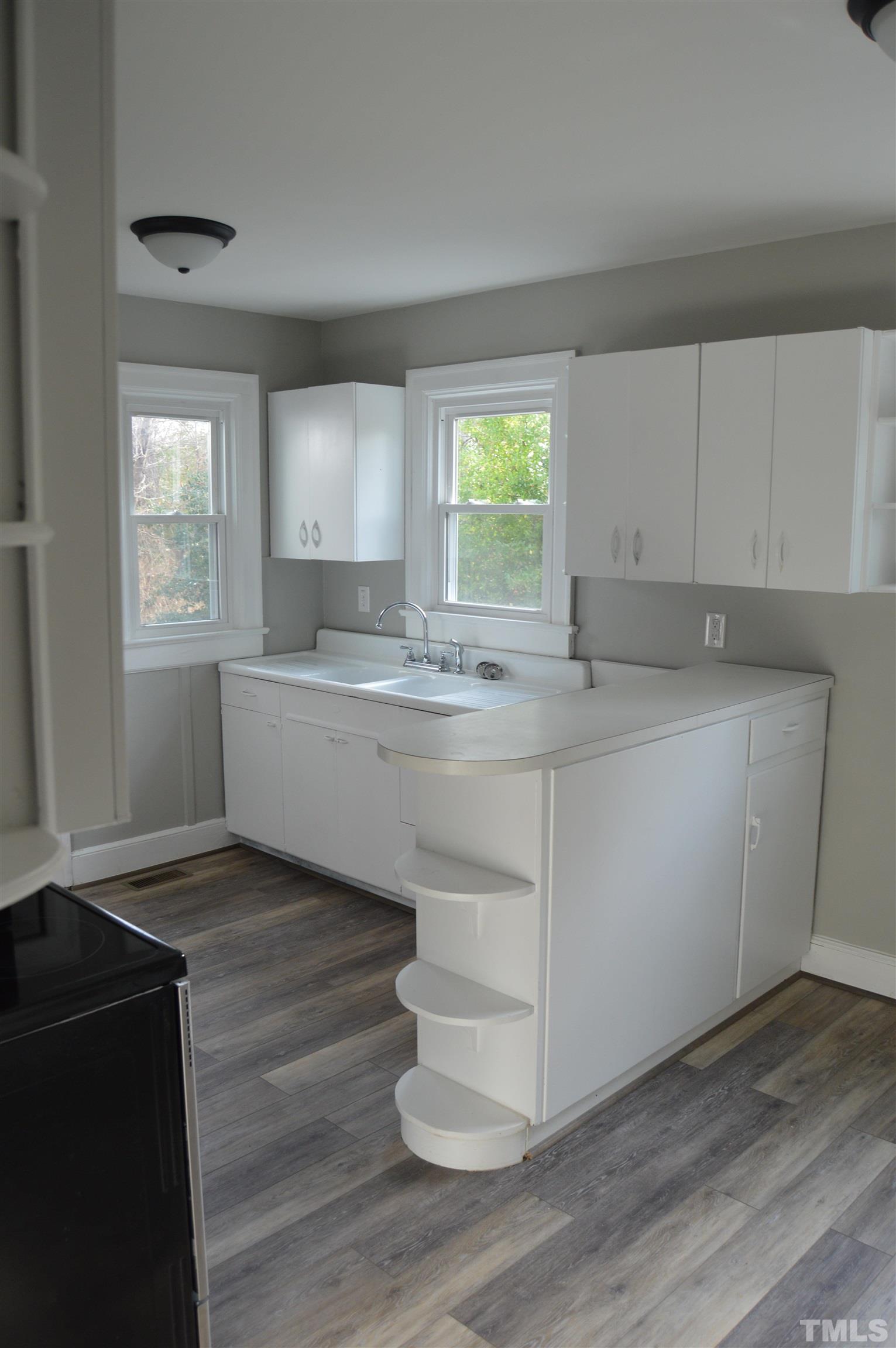 2123 Carthage Street Sanford, NC 27330 - Photo 17 of 18 a kitchen with a sink cabinets and window