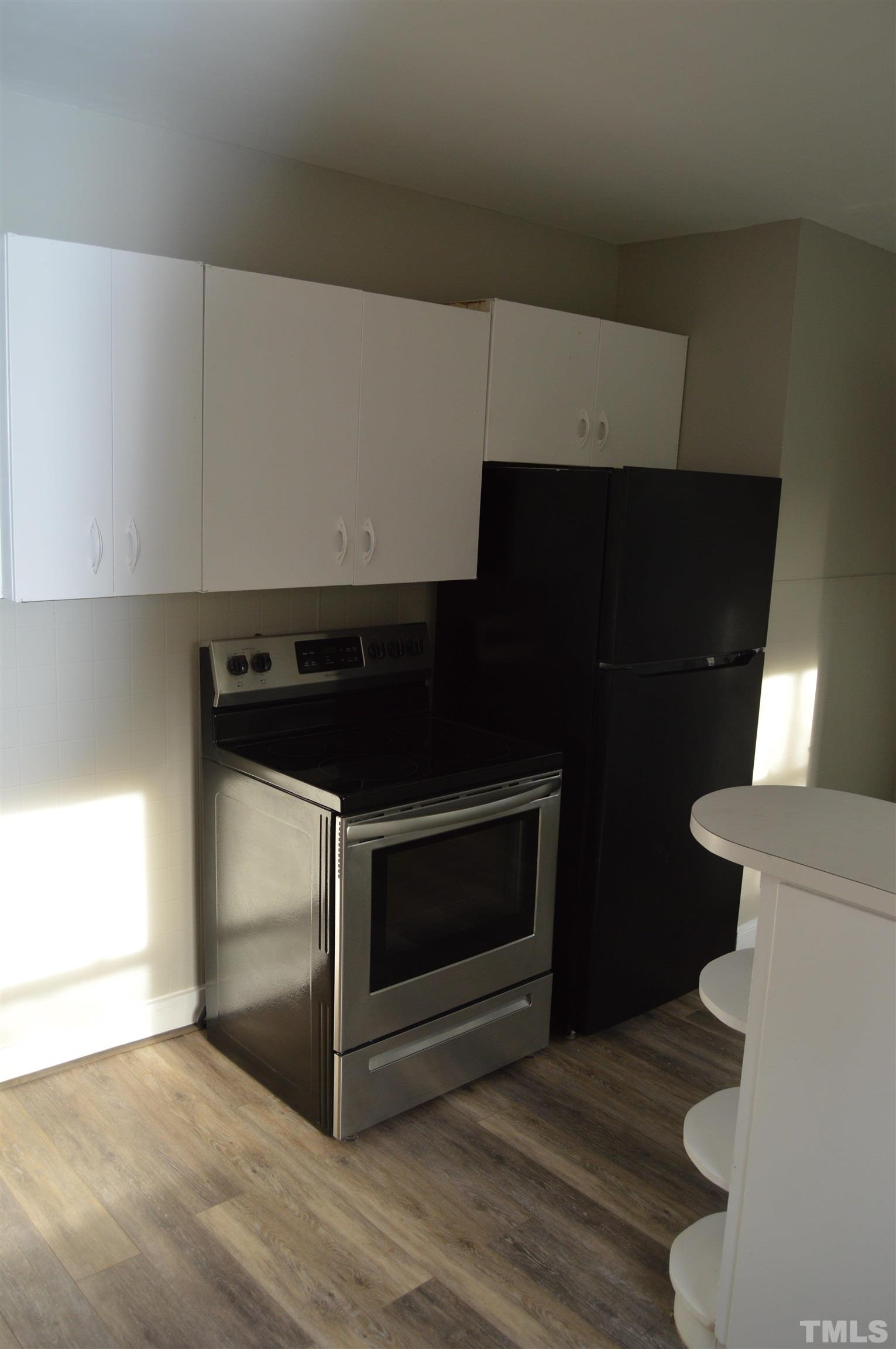 2123 Carthage Street Sanford, NC 27330 - Photo 18 of 18 a kitchen with granite countertop a stove and a microwave