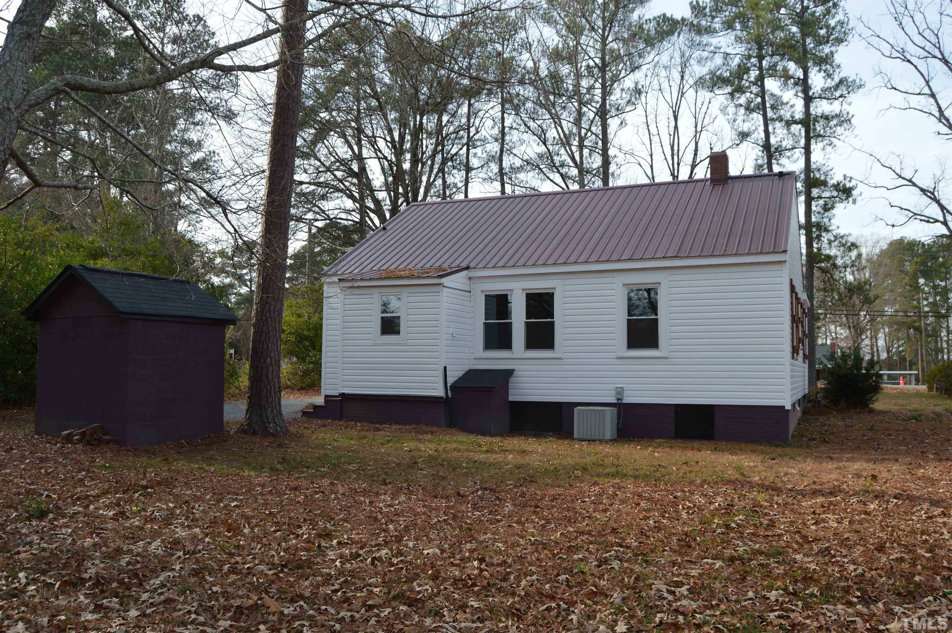 2123 Carthage Street Sanford, NC 27330 - Photo 4 of 18 a view of a house with a yard and wooden fence