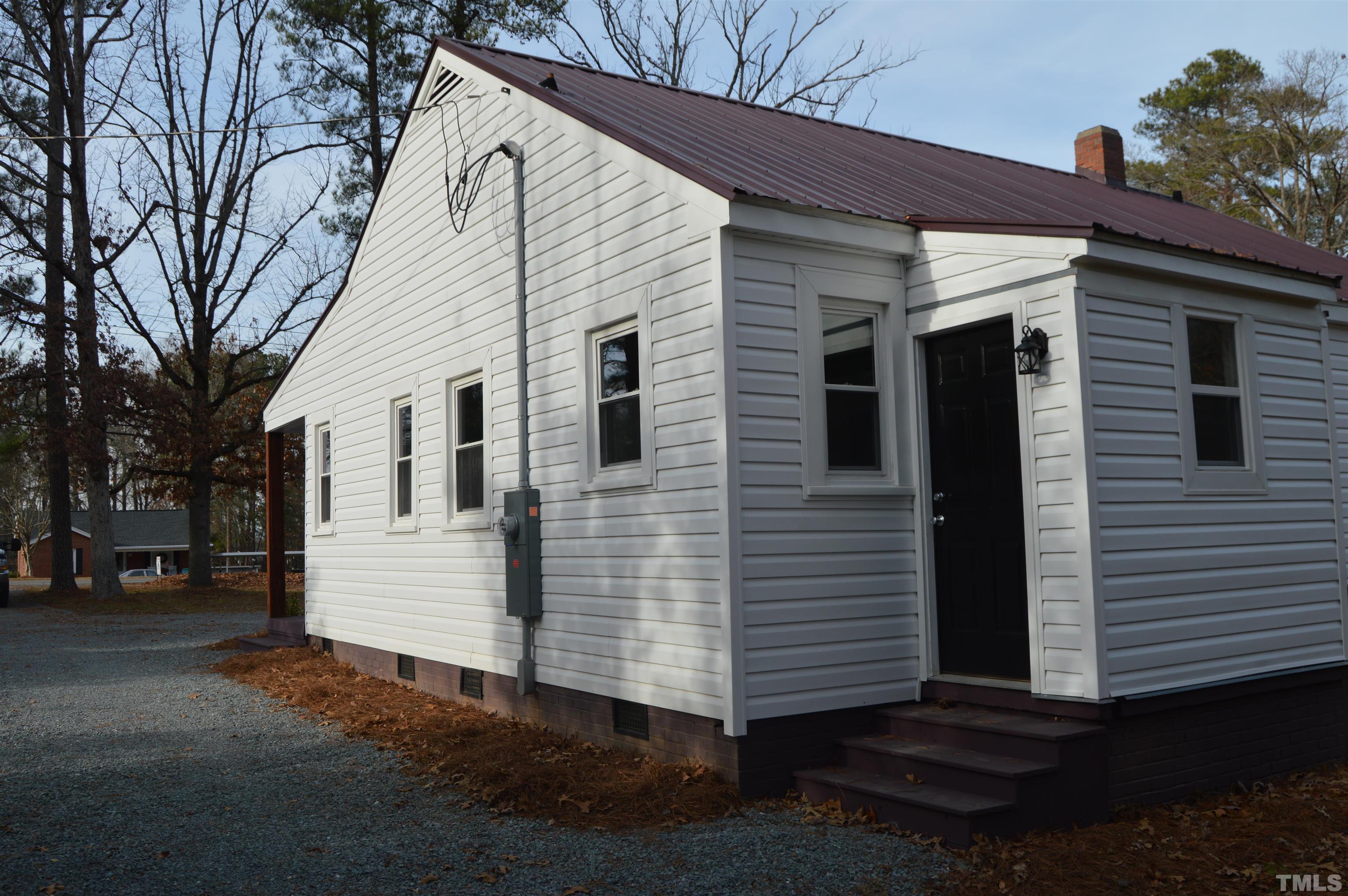 2123 Carthage Street Sanford, NC 27330 - Photo 5 of 18 a view of a white house with a yard