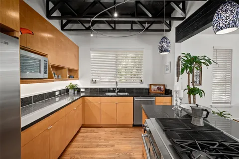 a kitchen with granite countertop lots of counter top space and wooden floor