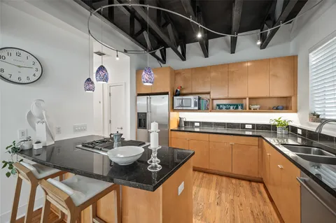 a kitchen with a table chairs stove and cabinets