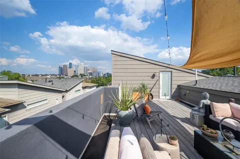 a outdoor living space with furniture and a flat screen tv