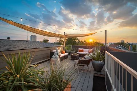 a terrace with outdoor seating and city view