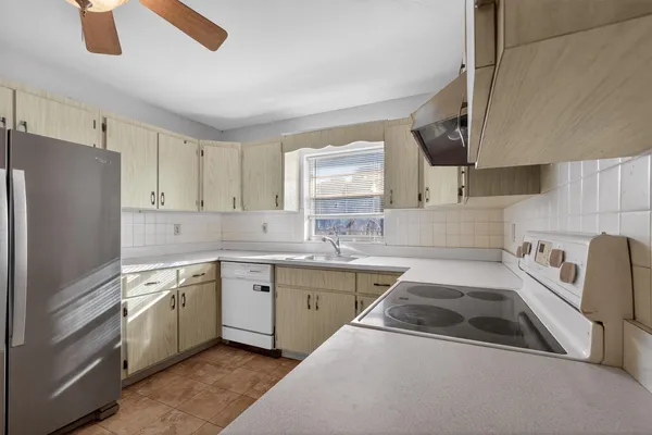 a kitchen that has a sink and a stove in it