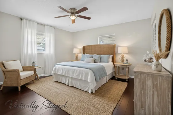 a bedroom with a large bed a chandelier and a couch