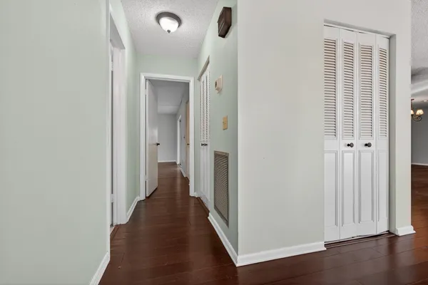 a view of a hallway with wooden floor