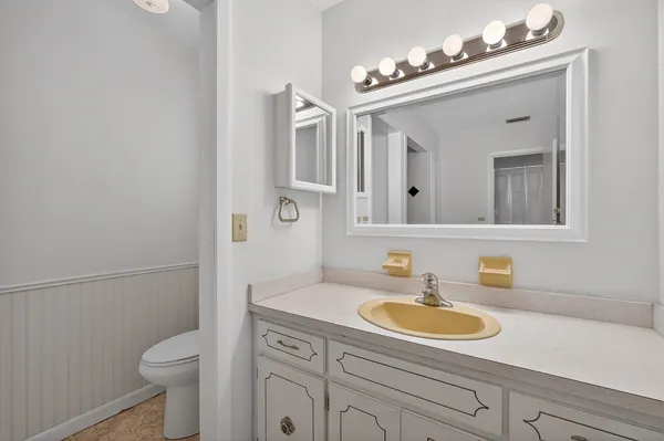 a bathroom with a sink toilet and mirror