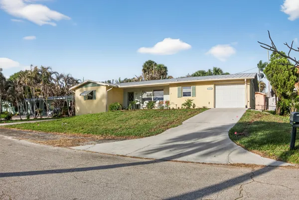 a view of a house with a yard and a garden