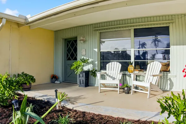 a view of living room filled with furniture and flowers